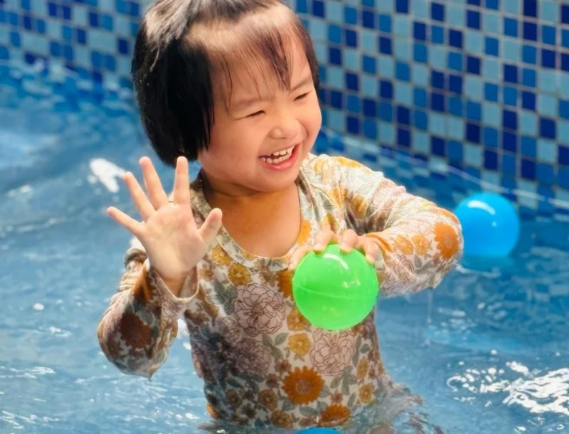 Trẻ chơi chuyền bóng tại hồ bơi phao
